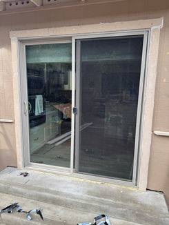 Close-up of a secure, modern sliding glass door frame installation with professional sealing.