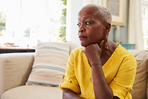 Senior Woman Sitting On Sofa At Home Suffering From Depression.jpg