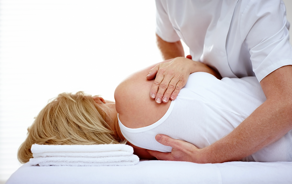 Male chiropractor adjusting a female patient