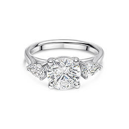 Round brilliant three-stone engagement ring with pear-shaped side diamonds