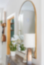 hallway styling on sideboard, lamp and gold mirror