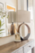 Styled hallway entrance with console table, mirror, and modern lamp in a Winchester residence.