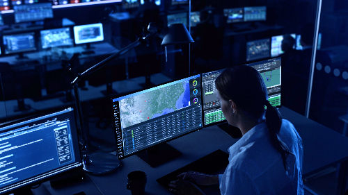 Visual effect shot of a woman using a monitor with a screen replacement effect tracked and applied