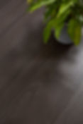 Dark timber look flooring with green leaves