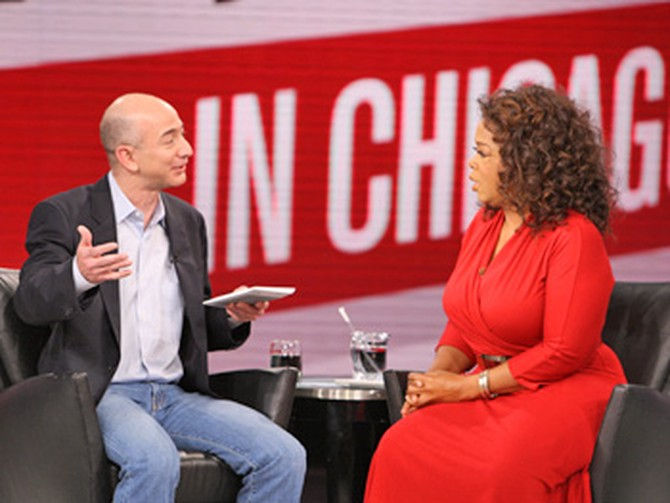 Jeff Bezos and Oprah Winfrey speaking on stage
