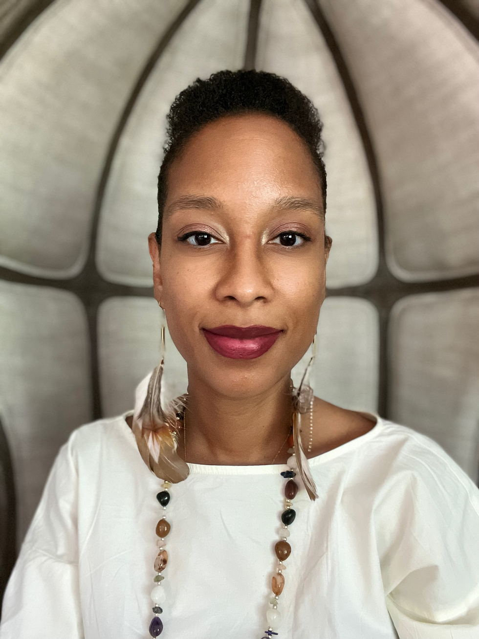Cadija Barnett, owner of Holistic Mental Health and Elemental Black Woman looking into the camera, black female therapist