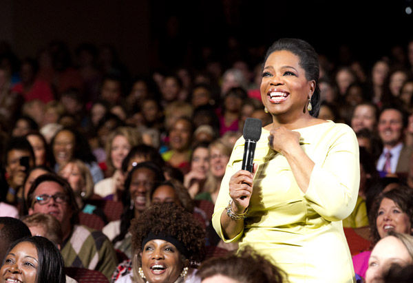 Oprah holding the mic in the middle of the audience