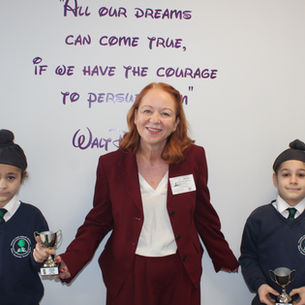 Judith celebrates chess success with pupils at Stocks Lane Primary