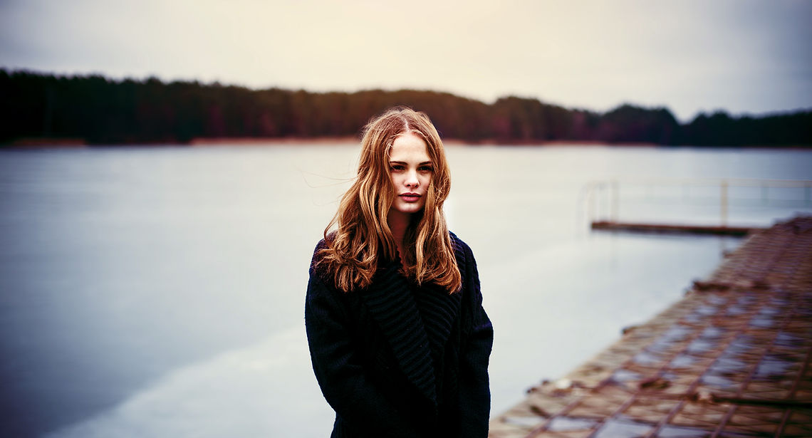Woman Standing on a Dark Pier