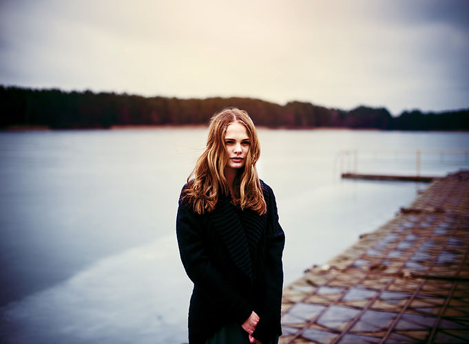 Woman Standing on a Dark Pier
