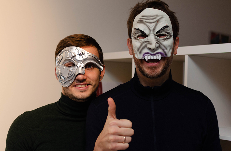 Two men smiling at camera in Halloween-themed fancy dress