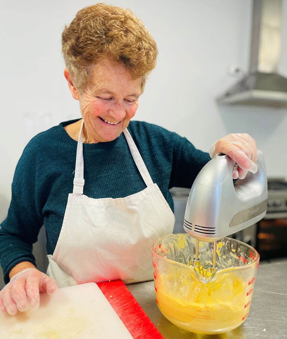 Rosie the volunteer baker at Balwyn Evergreen using an electric mixer.