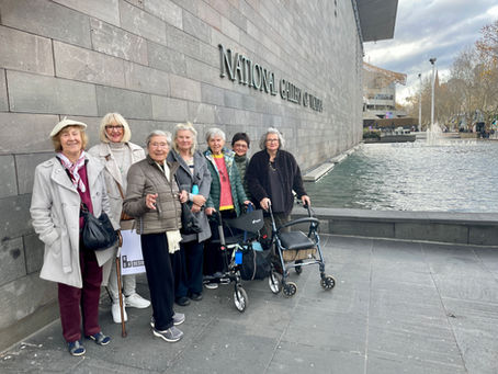 Group of older people outside the National Gallery of Victoria.
