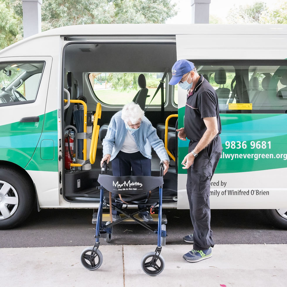 Volunteer driver helping a client off the bus at Balwyn Evergreen