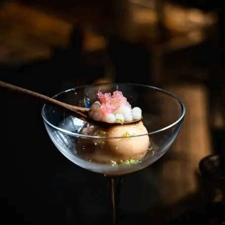 Saffron, yellow nectarine, finger lime, oolong rose, and gin cocktail crafted by Sydney-based beverage consultant Charlotte for Kurumba Surry Hills.