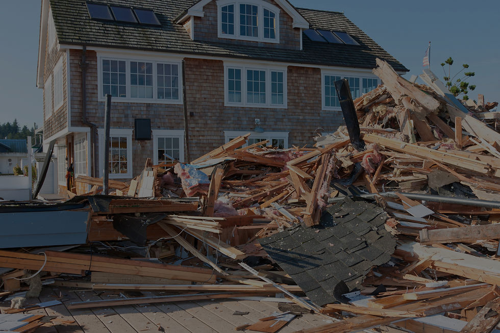 Large house in background with large pile of demolition waste in front