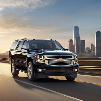 a luxury black Chevrolet suburban on a free way to another city.jpg