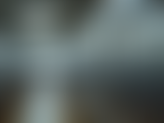 Eye-level view of a stainless steel bulk milk cooler in a dairy farm