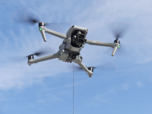 A gray DJI drone labeled "AIR 3" flies in a clear blue sky, propellers spinning, emitting a sense of calm.