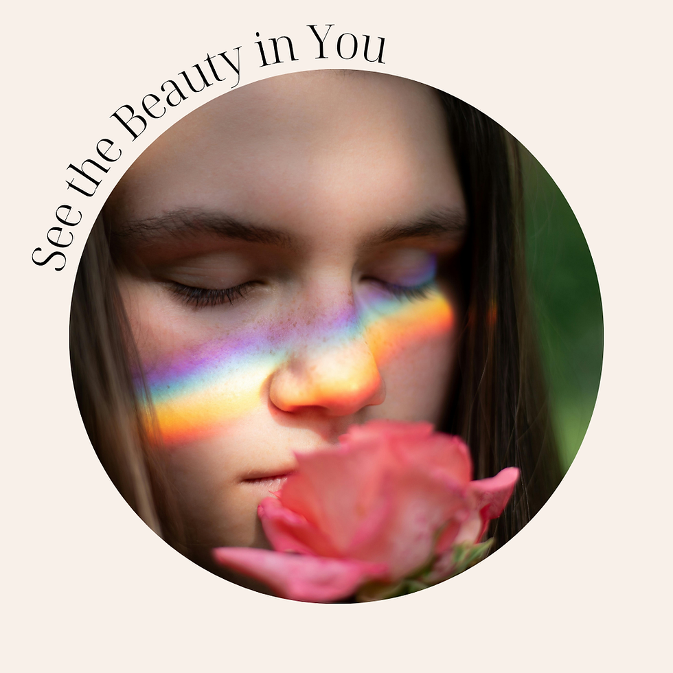 a girl with a rainbow on her face smelling a rose