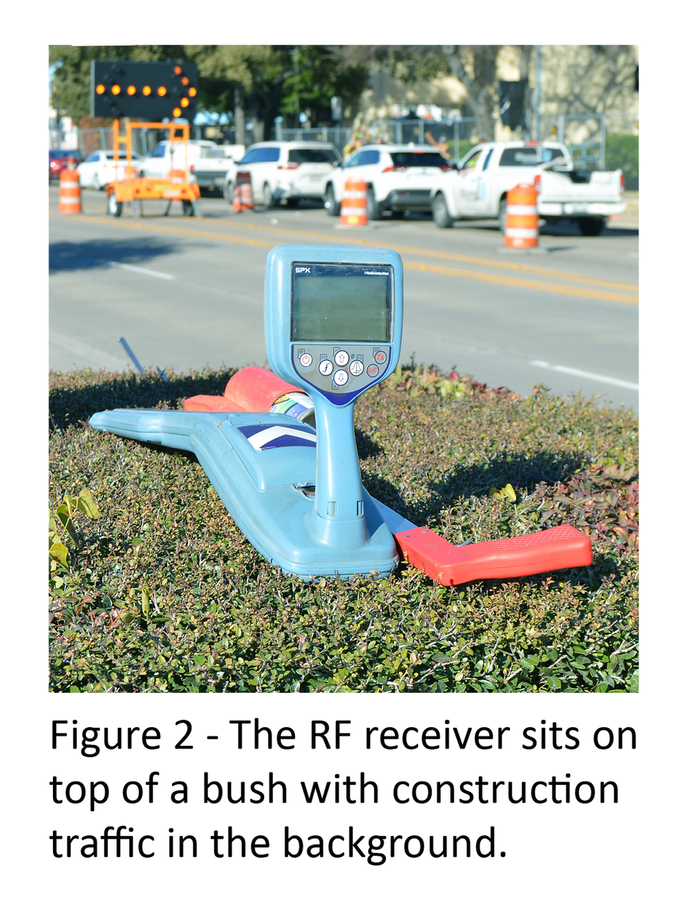 Figure 2 - The RF receiver sits on top of a bush with construction traffic in the background.