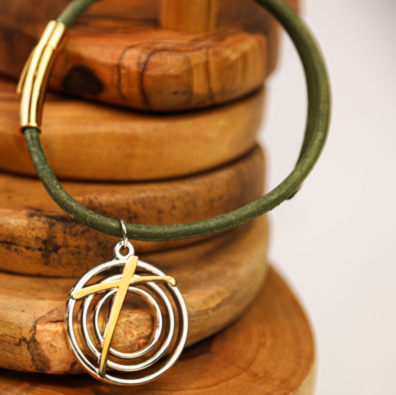 Natural green leather cord bracelet with duo-tone charm