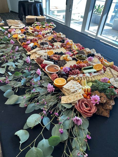 Charcuterie cups with prosciutto and aged cheddar set at each place for a Charlotte team lunch