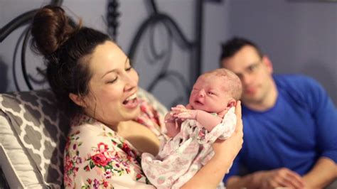 Happy Mom and Baby, Dad in Background.jp