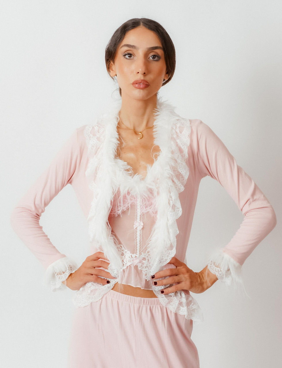 Model wearing the Princess Pink Pajama Set featuring lace and feather trim on a light pink top.