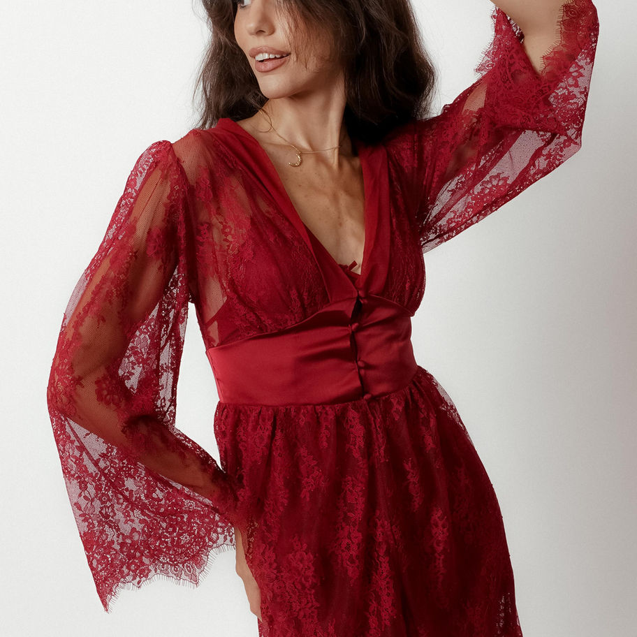 Model wearing Red Sheer Lace Robe with satin waistband and long lace sleeves.