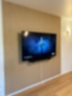 Modern TV mounted on wood slat wall in our projects