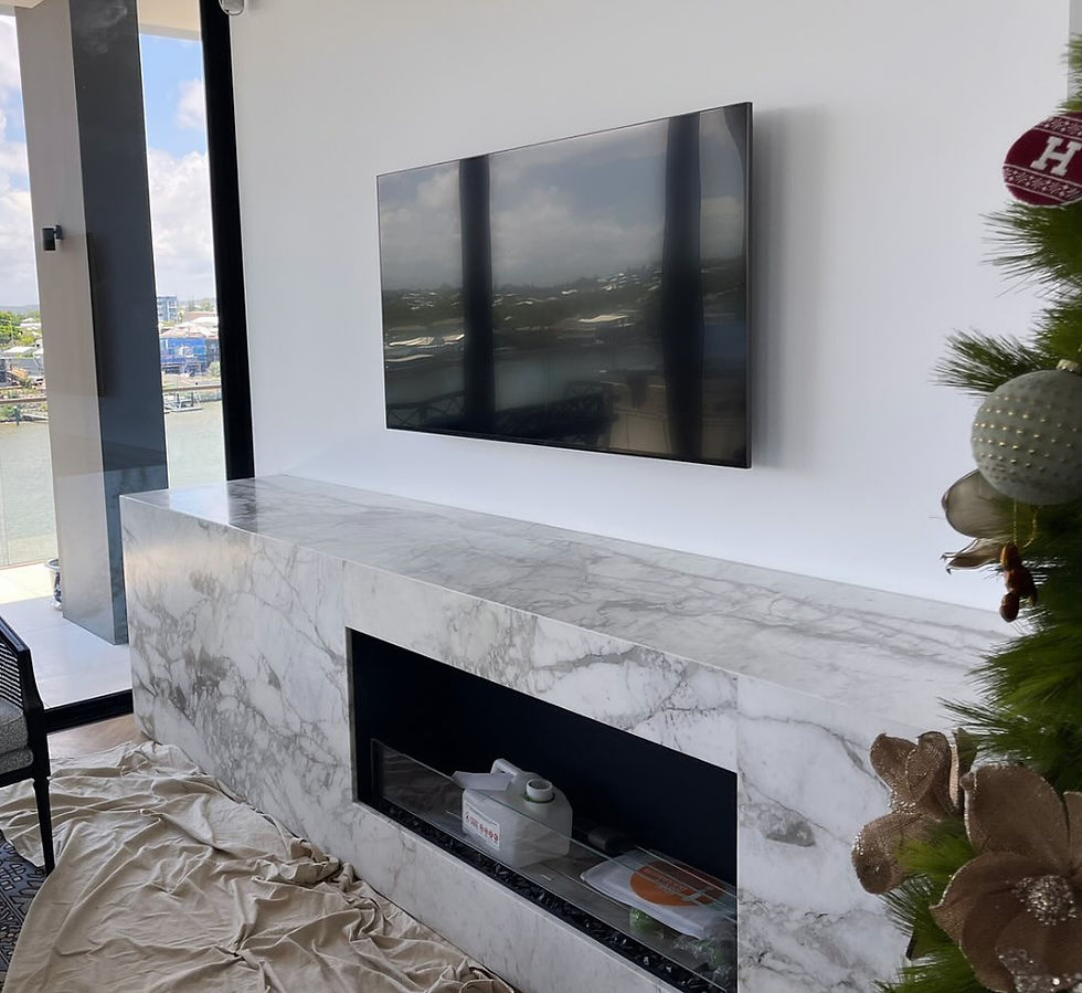 Modern marble fireplace under a wall-mounted TV.