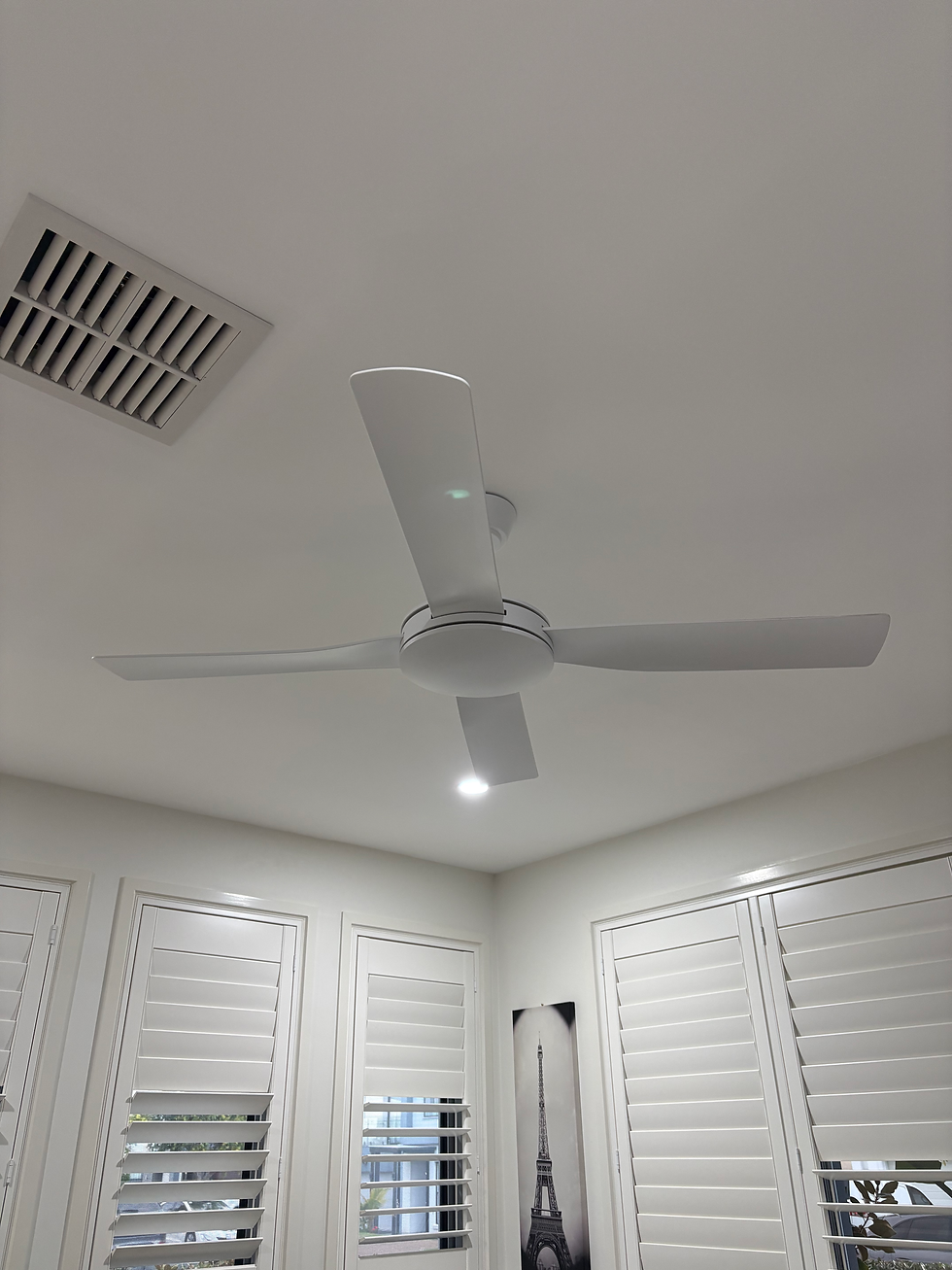 Modern white ceiling fan installation in a bright room.