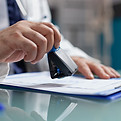 doctor-holding-medical-stamp-put-prescription-paper-health-care-exam-hand-physician-puttin