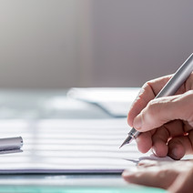 close-up image of a person's hand while holding a pen