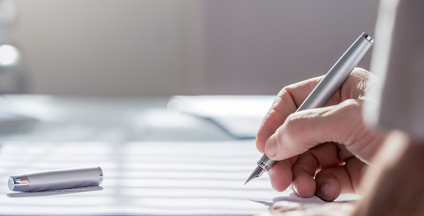 hand writing with a pen in a therapist questionaire document