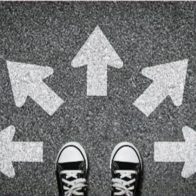 feet on pavement facing arrows