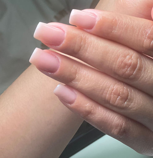 Close-up of natural ombre manicure with soft pink and white gradient at Pure Flawless Nails salon.