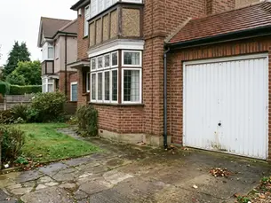 Attached single garage on a 1930s semi-detached house in North London before conversion into a room