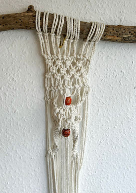 Cream macrame wall hanging with beads on wood