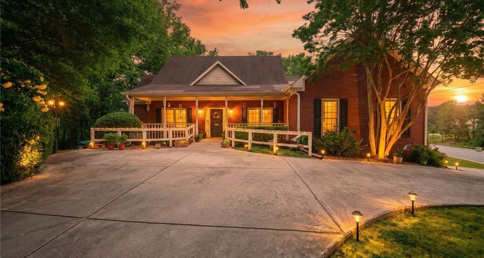 twilight exterior of 5030 Pine Mountain Rd NW Kennesaw GA with driveway and trees