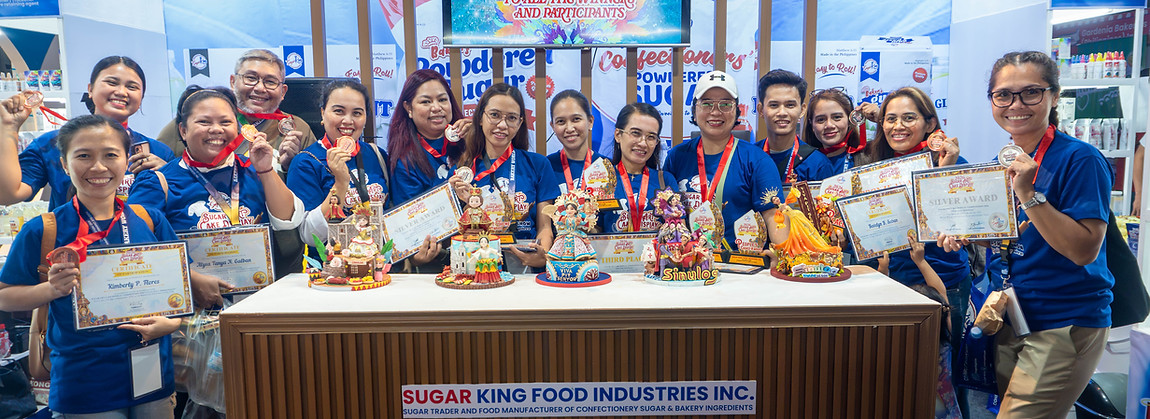 sacdc sinulog participants in a group photo at the sugar king booth
