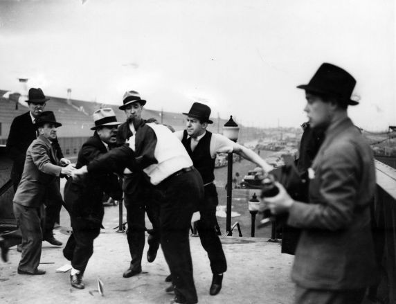 Harry Bennett roughs up union men.
