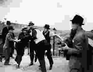 Harry Bennett roughs up union men.