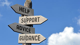 Wooden signpost with four arrows - "help