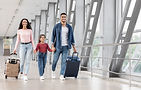Finally Vacation. Excited Smiling Arabic Family Holding Hands While Walking At Airport, Ha