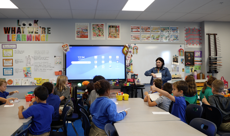Teacher explains lesson to students in classroom, 