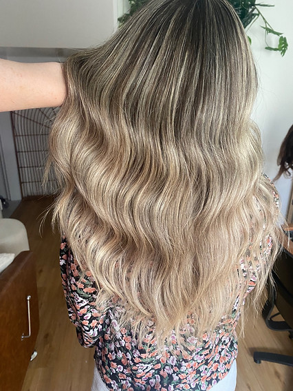 Woman showing her newly Blonde Hair with highlights