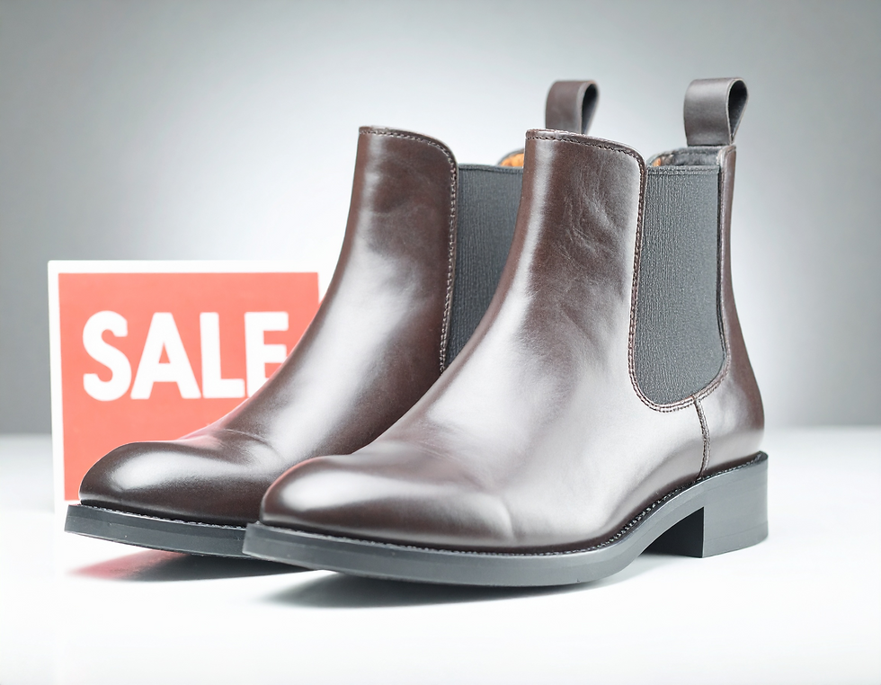 Brown leather boots on display with a red "SALE" sign in the background, set on a light grey surface.