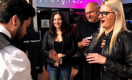 Apollo Riego performing close-up magic for guests at a Triumph Motorcycles corporate event in New York City.